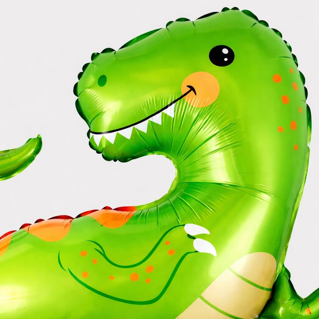 Close-up af grøn T-Rex folie ballon med detaljeret dinosaur ansigt og motiv til børnefødselsdag